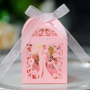 Detailed laser cut wedding gift box in pink featuring floral patterns and a ribbon tie