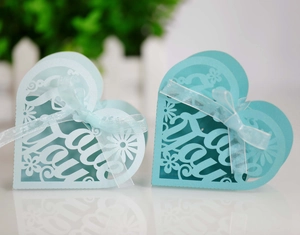 Detail of laser-cut heart candy boxes with Thank You engraving and white ribbons