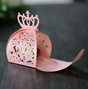 Pink laser-cut crown candy box with intricate floral patterns for weddings and parties