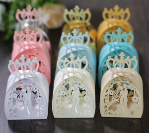 Detailed laser-cut wedding favor boxes with groom bride silhouette and crown tops