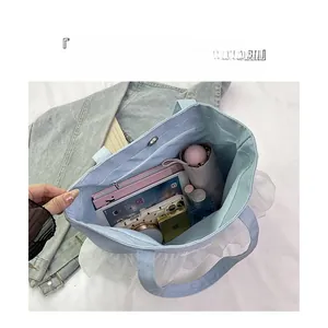 Internal view showing organized compartments of large denim tote bag with items