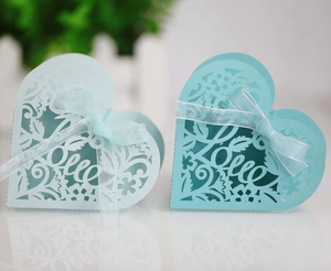 Laser-cut heart favor boxes with Love lettering and satin ribbons in light blue shades