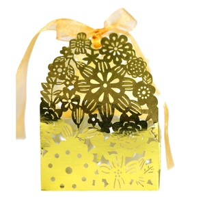 Elegant gold laser-cut hollow wedding favor box with a matching sheer organza ribbon