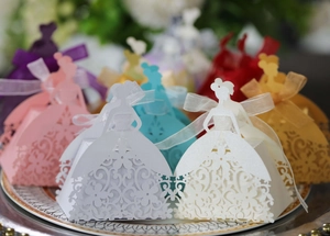 Macro detail of laser-cut wedding favor box with elegant girl silhouette and ribbon