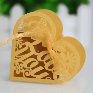 Golden laser-cut heart candy box with Love You text and ribbon for wedding favors