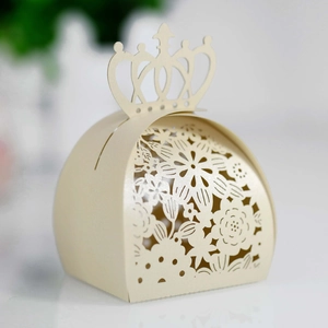 Detailed laser-cut floral patterns on crown-shaped cream paper wedding favor gift box