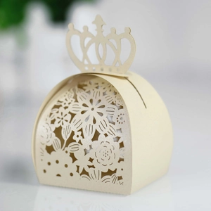 Detailed macro view of laser-cut crown pattern on champagne paper wedding favor box