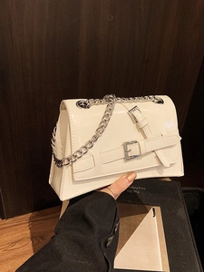 Chic cream white leather crossbody bag with silver chain strap and metal buckle detail
