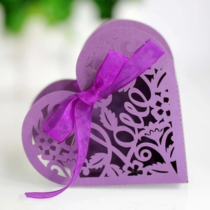 Close-up of purple heart-shaped gift box with laser-cut LOVE text and satin ribbon