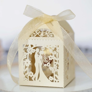 Detail showing laser-cut bride and groom silhouette on cream pearl paper favor box