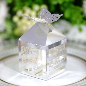 Macro shot of silver mirror laser-cut butterfly gift box with Happy Birthday cutouts