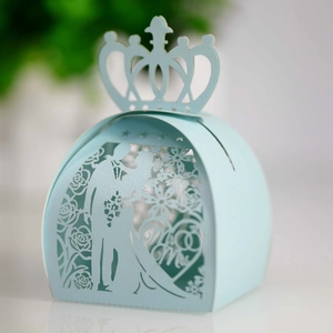 Macro detail of a laser-cut light blue wedding candy box with Mr & Mrs crown design