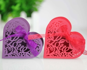 Close-up of laser-cut heart candy boxes with Love text and decorative ribbons