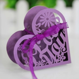 Detail of purple laser-cut heart candy box with silk ribbon and floral Love pattern