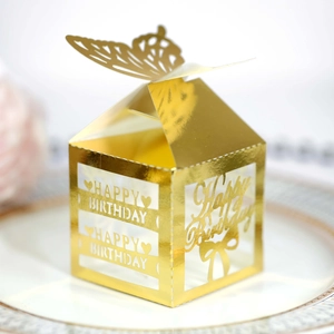 Detail of laser-cut Happy Birthday lettering on golden butterfly favor gift box