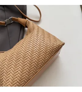 Detailed macro view of woven khaki tote bag showing intricate cross-weave craft texture