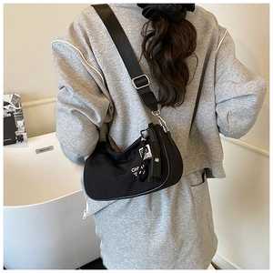 Model view of a black nylon crescent crossbody bag with an adjustable wide strap