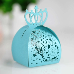 Close-up of sky blue laser-cut candy box with crown top and floral pattern