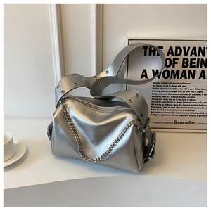 Silver shoulder bag with metal chain and wide strap detail in minimalist aesthetic