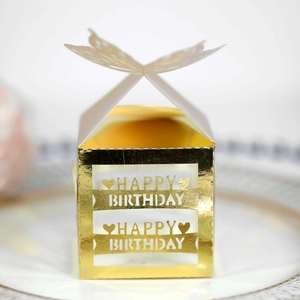 Detail of laser-cut gold pearlescent paper candy box with butterfly top and Happy Birthday text