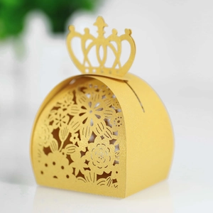 Detail of golden laser-cut candy box featuring crown top and elegant floral patterns