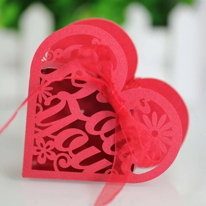 Red heart laser-cut candy box with floral patterns and red organza ribbon detail