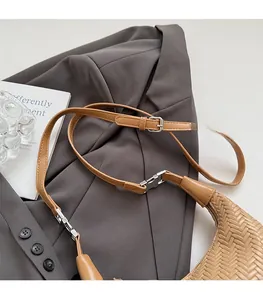 Detailed macro view of woven brown leather texture and adjustable smooth shoulder strap