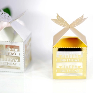 Detail of laser-cut butterfly gift boxes with Happy Birthday heart cutouts in gold and silver