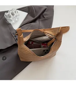 Interior detail of the woven dumpling bag showing large storage space for essentials