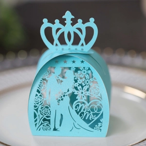 Macro view of light blue laser cut wedding favor box with Mr & Mrs heart crown design