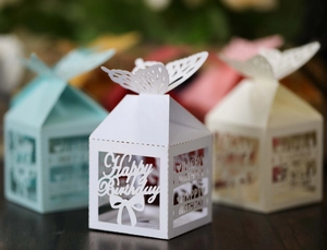 Macro shot of laser-cut butterfly gift boxes with Happy Birthday镂空 design for parties