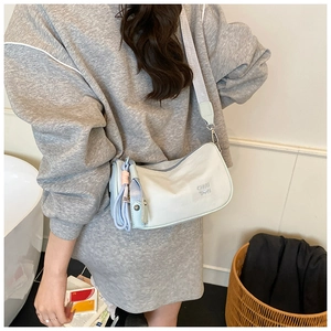 Close-up of light blue pillow bag featuring CHUU TOWN print and wide canvas strap