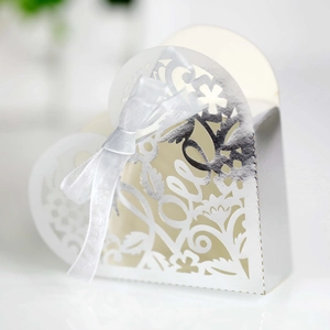 Macro shot of silver hollow heart candy box with laser-cut floral patterns and LOVE logo