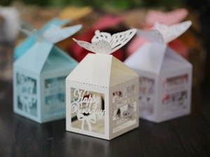 Macro detail of laser-cut Happy Birthday candy boxes with hollow butterfly top design