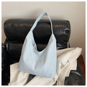 Detailed close-up of light blue nylon tote bag with high-quality MVICHI embroidery
