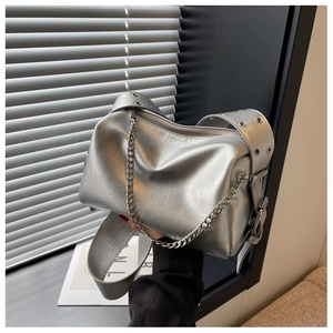 Detail of silver metallic wrinkled leather handbag with eyelet strap and chunky chain