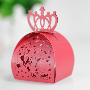 Detail of laser-cut crown gift box with intricate floral patterns in red pearlescent cardstock