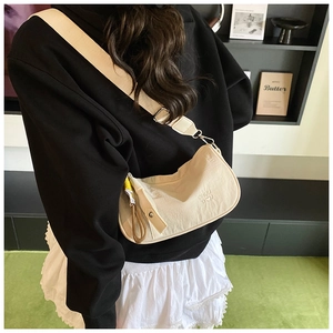 Creamy white half-moon crossbody bag with CHUU DON embossed text and adjustable wide strap