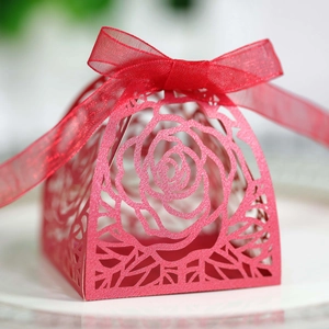 Dettaglio scatola di caramelle rosa tagliata al laser rossa con glitter e nastro in organza