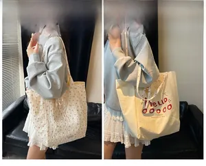 Detail of reversible cotton canvas tote bag showing floral pattern and Hello text print