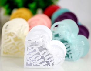 Macro shot of laser-cut heart candy box with Love You text and white ribbon bow