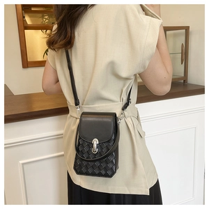 Detail of black woven leather mini crossbody bag with silver U-shaped metal buckle