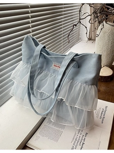 Blue denim tote bag with white lace ruffle trim and heavy-duty canvas handles