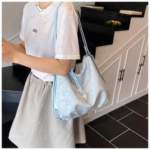 Close-up of light blue floral jacquard texture with elegant pearl drawstring detail