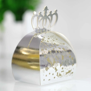 Macro detail of silver mirror laser-cut crown candy box with intricate floral patterns