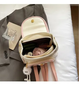 Internal layout of a cream and pink backpack showing storage for umbrella and wallet