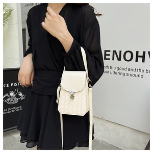 Close-up of cream crossbody bag featuring woven texture and silver metallic lock