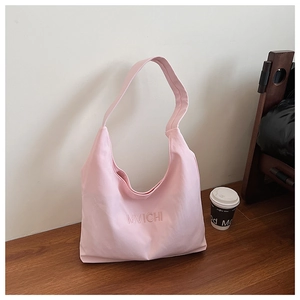 Detail of soft pink nylon tote bag with embroidery, perfect for casual commute use