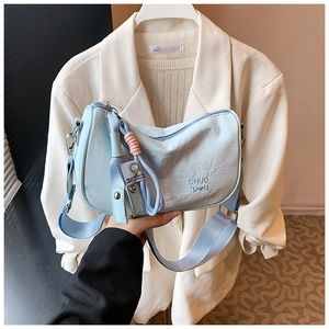 Detail of light blue hobo bag with pleated texture and stylish shoulder strap