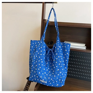 Close-up of blue floral cotton tote bag with Magic Pocket label and detailed fabric texture